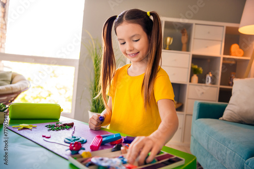 Photo of positive pretty girl playing alone making handmade plasticine masterpiece homework task remotely education indoors