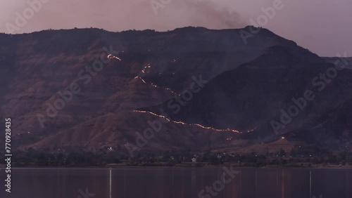 Timelapse - Wildfires on a mountain by a lake 4K60 photo