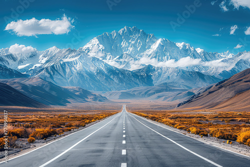 A wide road leads to the snowcapped mountains of Tibet, with photorealistic landscapes and minimalist backgrounds under a bright blue sky. Created with Ai photo