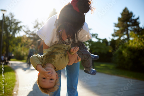 Woman entertaining kid in the park photo