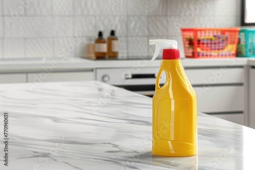 Yellow spray bottle of liquid detergent on a white marble countertop in a bright kitchen. Place for text. Spring cleaning concept.