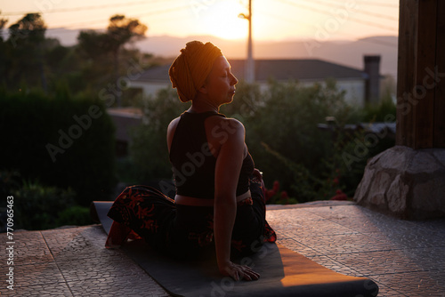 Cancer survivor woman doing yoga outdoors photo
