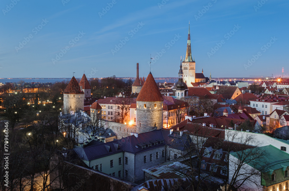 Tallinn cityscape with Saint Olaf's church and old town walls and towers at sunset, Estonia