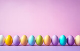 Row of easter painted eggs on violet background.