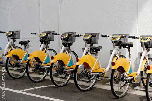 Yellow bikes in parking photo