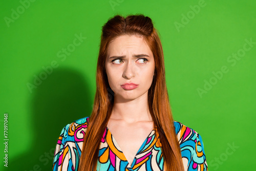 Photo portrait of attractive young woman look moody sad empty space dressed stylish retro clothes isolated on green color background © deagreez