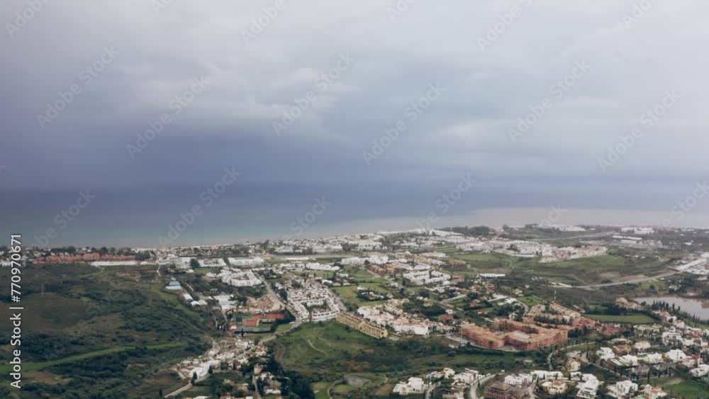 Aerial shot of a coastal city under cloudy weather. Aerial shot of a coastal city under cloudy weather.