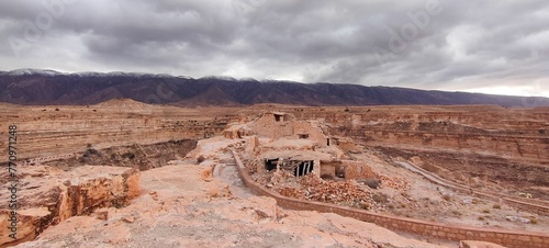 The balconies of Ghoufi, ancient Berber village, with stone and clay houses, carved into waterfalls in the rock, and the river which waters the oasis of palm trees and fruit trees. Batna. Algeria photo