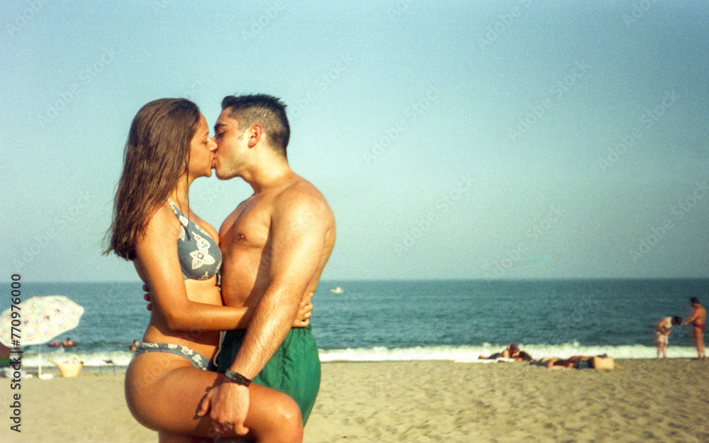 teenage couple kissing on the beach teenage couple kissing on the beach