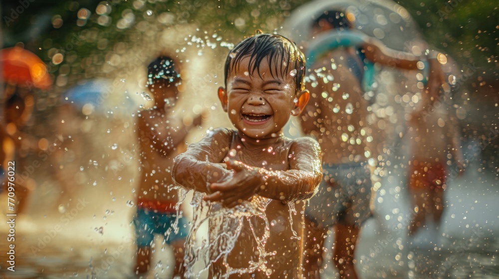 Adorable children playing and splashing water together in Songkran Festival Adorable children playing and splashing water together in Songkran Festival