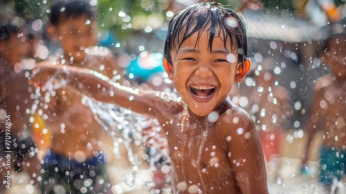 Adorable children playing and splashing water together in Songkran Festival