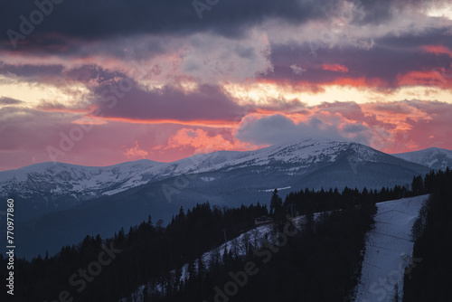 Dramatic orange sunset on ski resort Bukovel in Ukraine. photo