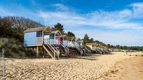 Traditional wooden beach huts on the sand in Wells on the North Norfolk coast