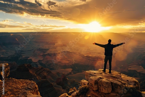 Man with arms wide open at Grand Canyon during sunset © BetterPhoto