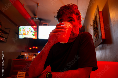 Man Drinking Beer On A Bar  photo