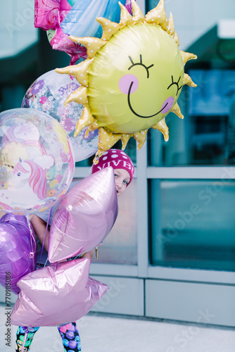 Child cancer patient hiding in balloons