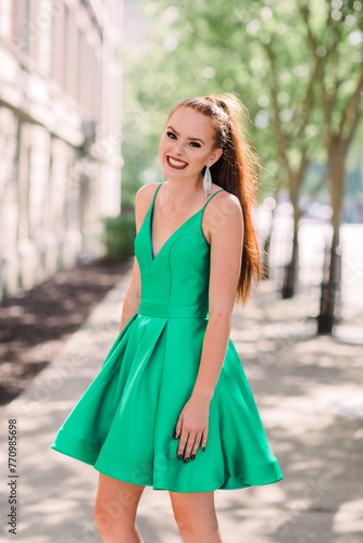 portrait of a red-headed woman in green dress