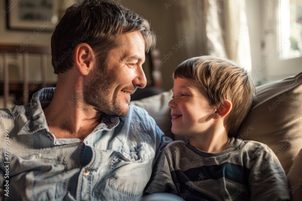 Smiling boy and father enjoying a conversation Smiling boy and father enjoying a conversation