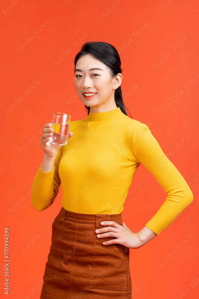 portrait of attractive asian smiling woman holding a glass of water portrait of attractive asian smiling woman holding a glass of water
