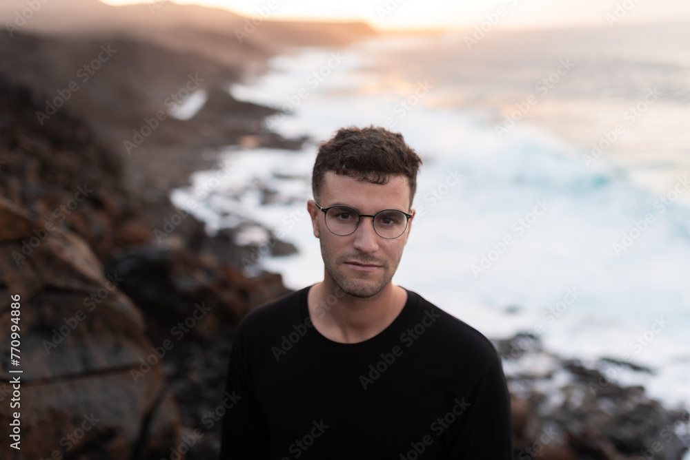 Portrait of a young man with a sunny seascape in the background Portrait of a young man with a sunny seascape in the background