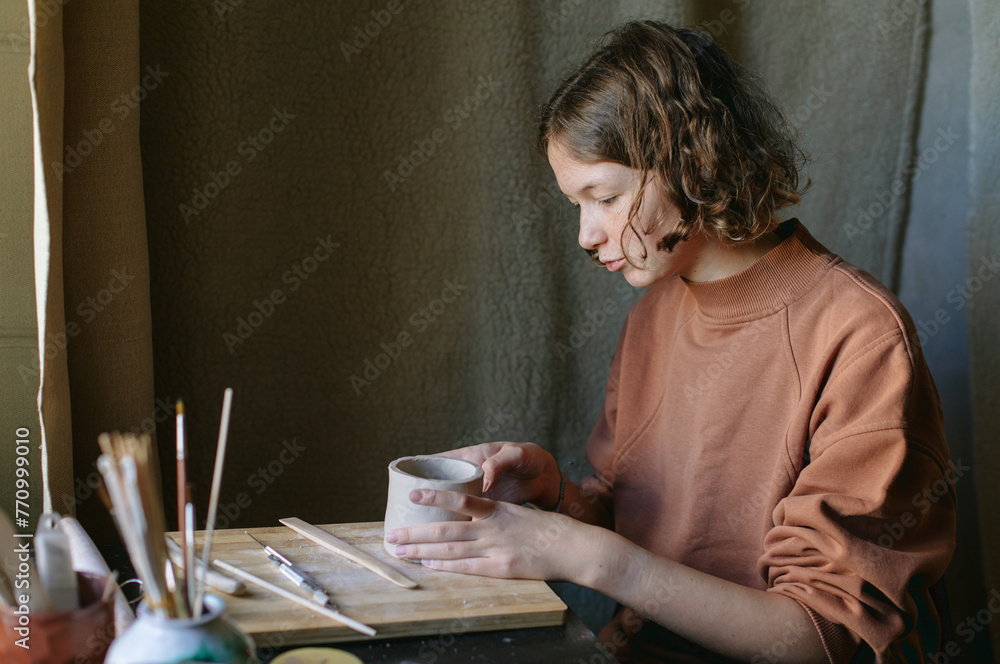 potter girl working at the table
potter girl working at the table