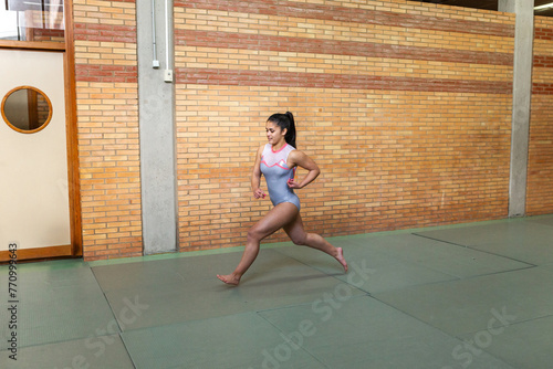 Gymnast teen girl in her artistic gymnastics training photo