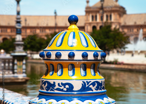 Plaza de Espana, Seville, close up of decorated ceramic pot with buildings behind and lake