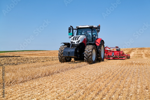 Obraz na plátně The tractor works on the stubble with reduced tillage