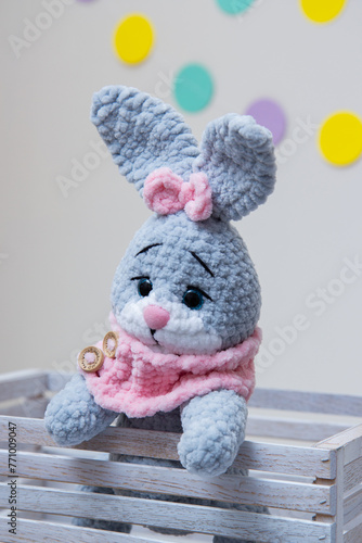 gray bunny soft toy with pink scarf