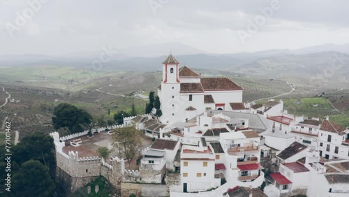 Drone of white town with the church at the top of the hill, Alozaina in Andalusia, Spain photo