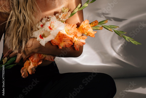Sensual faceless woman with bouquet of flowers photo