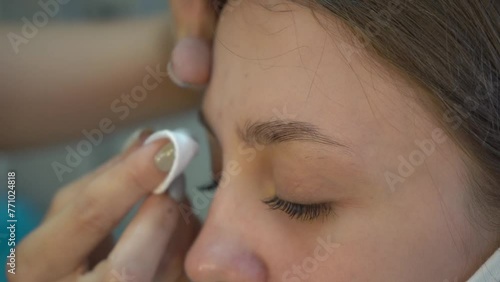 Beautician prepares eyebrows for coloring and shaping