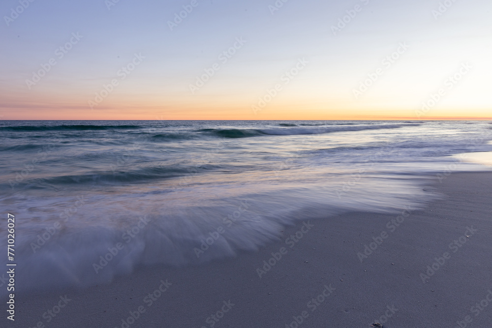 Sunset at Beach with slow shutter, blurred water showing the gentle movement,