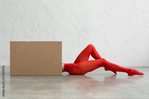 Performance of athletic woman in bright red tights with craft bo