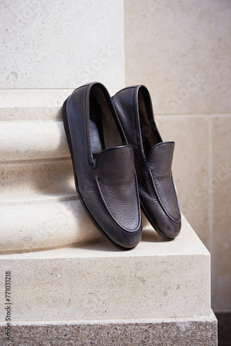 Stylish men's shoes stand on a column pilaster photo