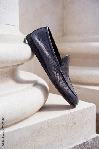 Stylish men's shoes stand on a column pilaster photo