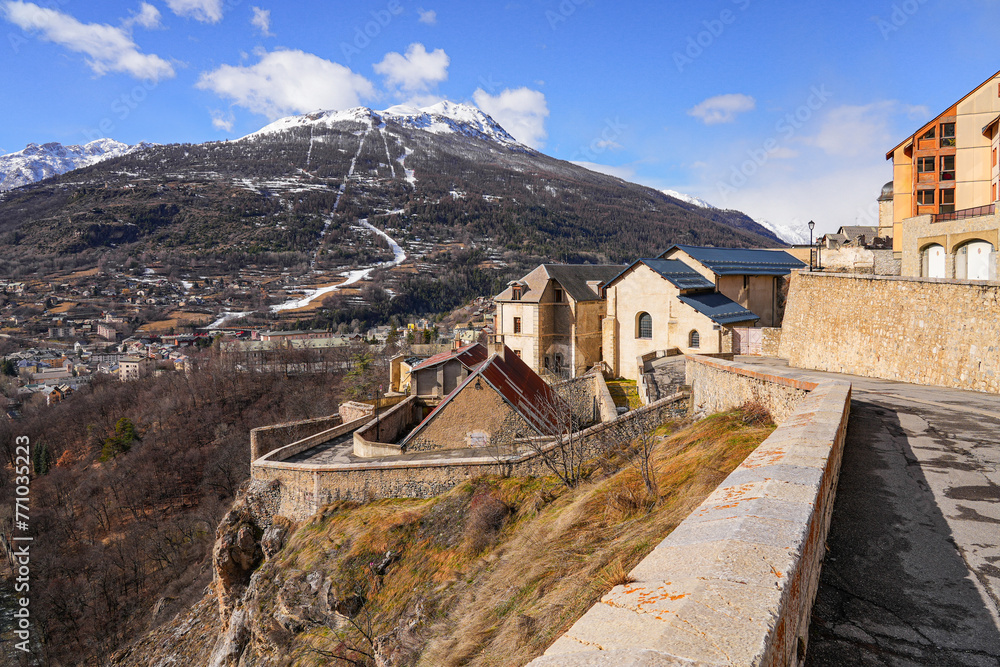 Walled city of Briançon built by Vauban in the French Alps - Citadel with colorful houses on top of a rocky spur in a mountainous valley in France