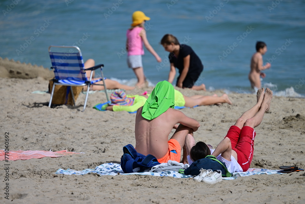 A young man doing sportive exercises at the beach of Benidorm-Spain on a hot and windy april day. A young man doing sportive exercises at the beach of Benidorm-Spain on a hot and windy april day.