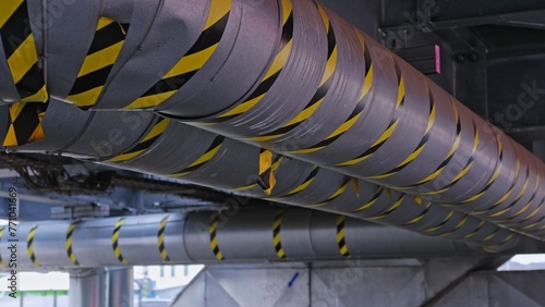 Industrial Ventilation Duct Piping Marked with Black and Yellow Safety Tape