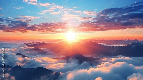 Beautiful golden sunset above cloud with sun shinning on horizon and mountain.