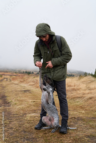 A man and his dog in the mountain photo