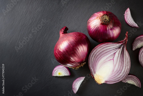 red onion on presentation board and black background