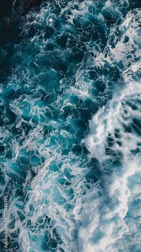 Overhead view of turbulent ocean waves captured in vivid shades of blue and white