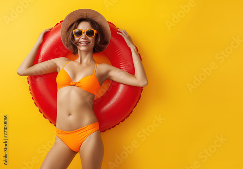 Beautiful cheerful brunette woman in a inflammable ring and smiling. Isolated background with empty space. Summer vacation and travel concept.