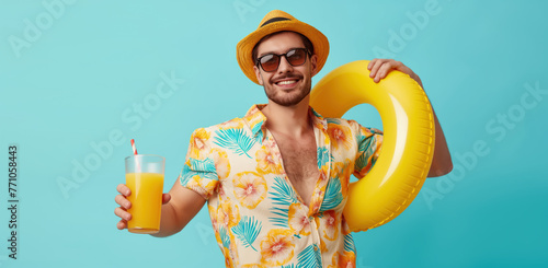 Man in a infallible ring holding cocktails. Blue background with empty space. Summer vacation and travel concept photo