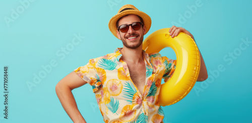 Man in a infallible ring holding cocktails. Blue background with empty space. Summer vacation and travel concept photo