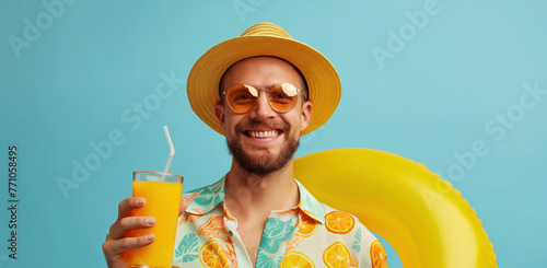 Man in a infallible ring holding cocktails. Blue background with empty space. Summer vacation and travel concept photo