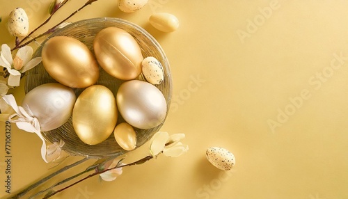 easter golden decorated eggs on yellow background minimal easter concept happy easter card with copy space for text top view flatlay