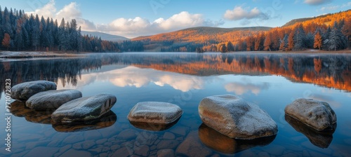 Vibrant high tatra lake autumn sunrise with colorful mountains and pine trees in serene nature