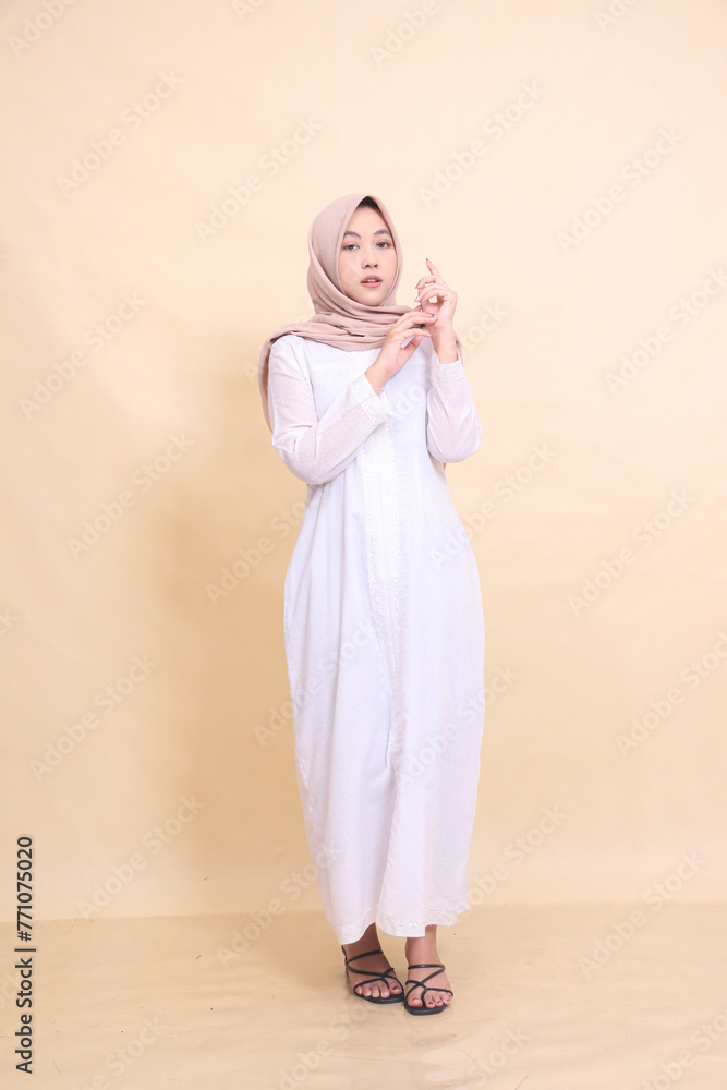 full body woman indonesia wearing beautiful dress elegant pose isolated on cream background - beauty, model, studio and fashion concept full body woman indonesia wearing beautiful dress elegant pose isolated on cream background - beauty, model, studio and fashion concept